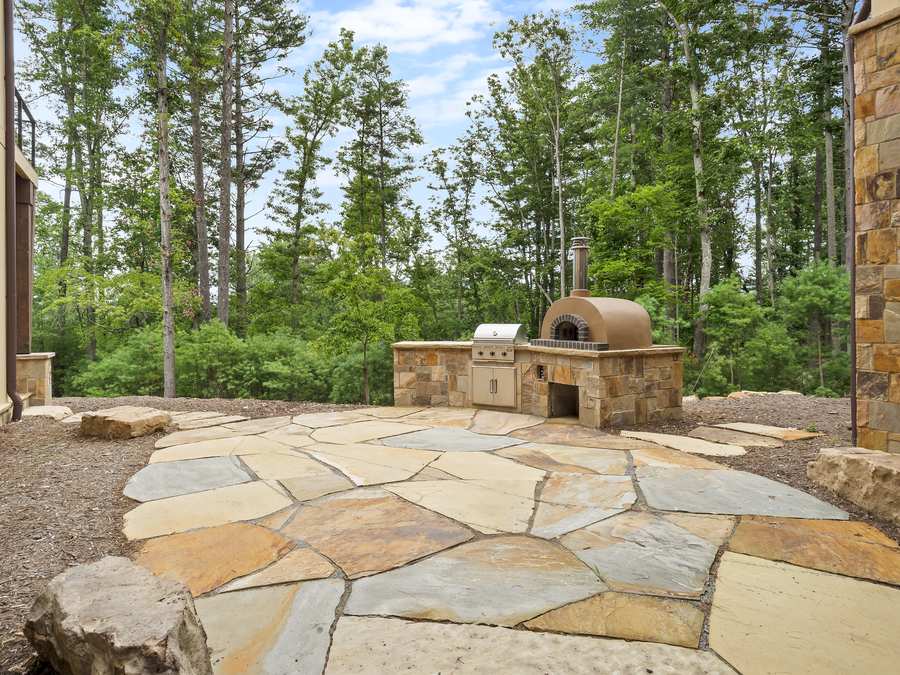 Flagstone patio with an outdoor pizza oven
